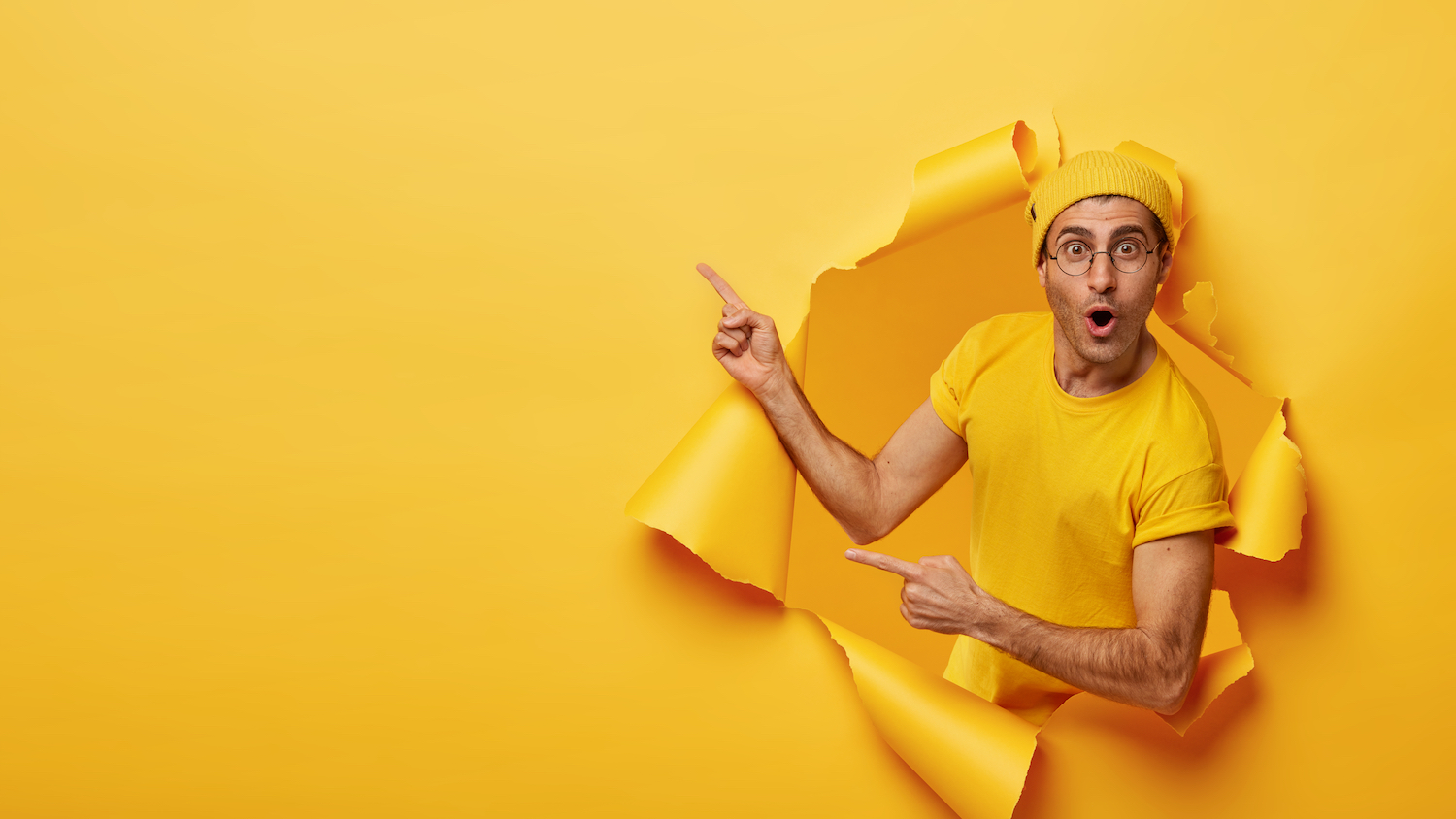 Indoor,Shot,Of,Impressed,Delighted,Unshaven,Man,Points,Away,At